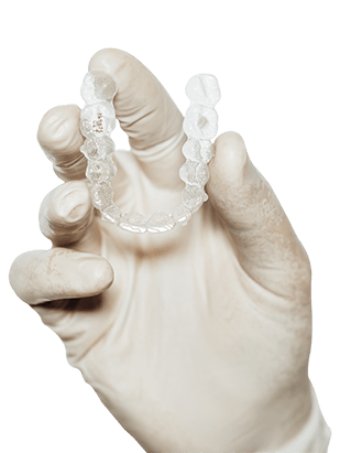 dentist-holding-clear-dental-aligner